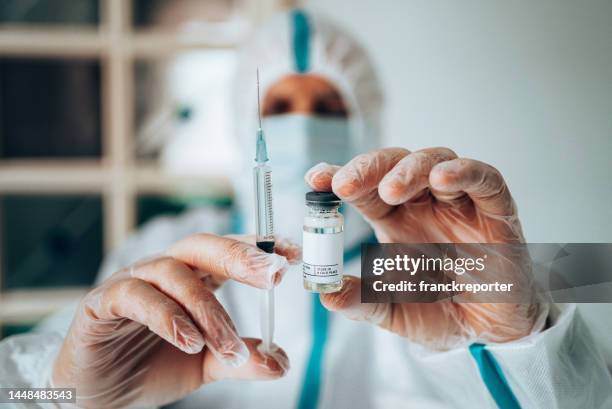 man holding a covid vax shot - alpha males stock pictures, royalty-free photos & images