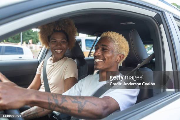 couple in a car driving - driving romance stock pictures, royalty-free photos & images