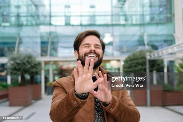 portrait of cheerful caucasian man laughing out loud outdoors - pants down bildbanksfoton och bilder