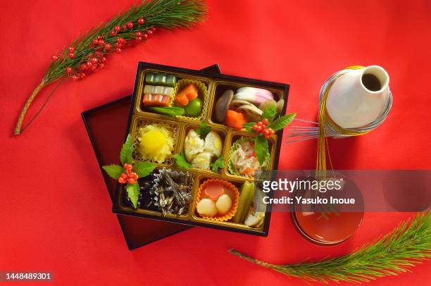 osechi box & sake for a new year days - osechi ryori stock pictures, royalty-free photos & images