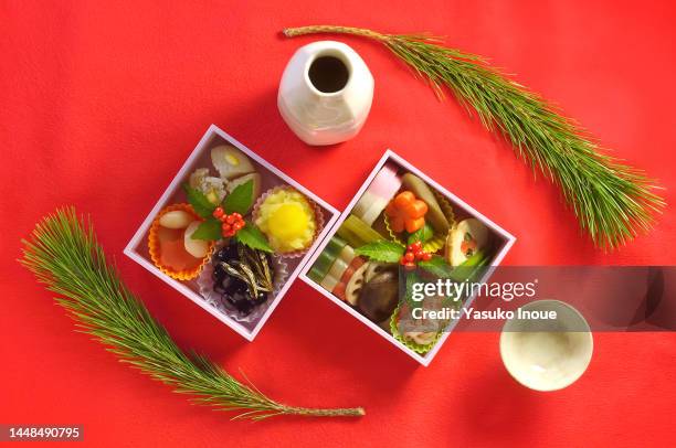 osechi box & sake for a new year days - osechi ryori stock pictures, royalty-free photos & images