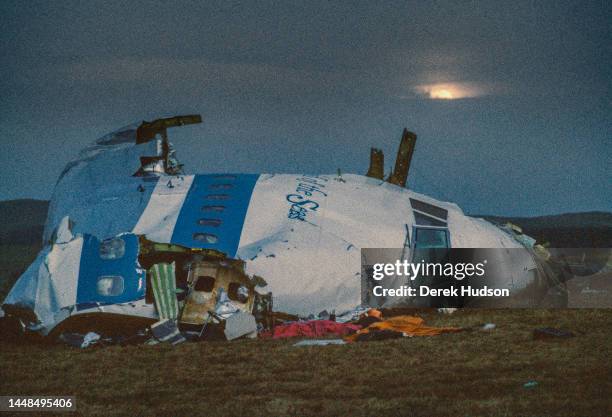 The nose cone of a Boeing 747, Pan Am flight 103 lies in a field near the the Scottish town of Lockerbie. In the foreground next to an orange blanket...