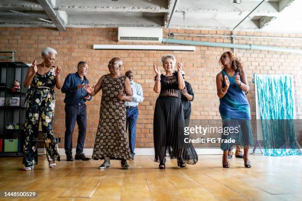 senior friends dancing on a dance hall - zumba class stock pictures, royalty-free photos & images