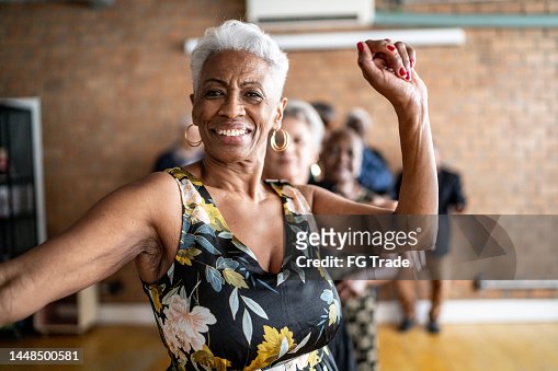 Portrait of a senior woman dancing with her friends on a dance hall