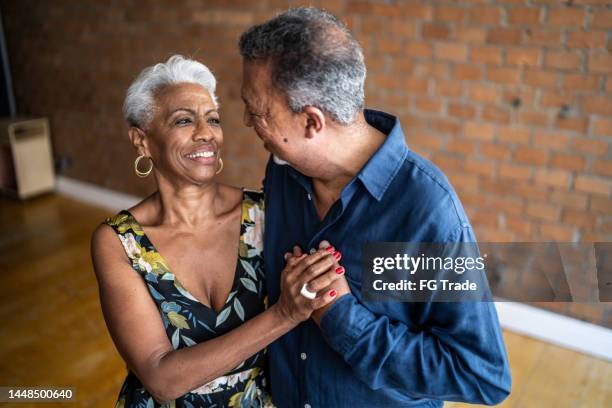 senior couple dancing waltz in dance hall - older couple ballroom dancing stock pictures, royalty-free photos & images