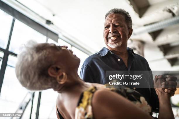 happy senior couple dancing at home - older couple ballroom dancing stock pictures, royalty-free photos & images