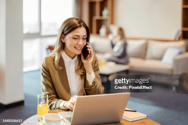 business woman talking on phone - business class lounge stock pictures, royalty-free photos & images