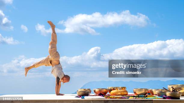 man doing yoga on deck - music therapy stock pictures, royalty-free photos & images