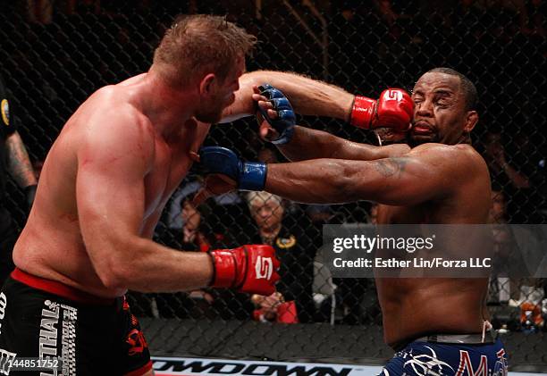 Josh Barnett punches Daniel Cormier during the Strikeforce event at HP Pavilion on May 19, 2012 in San Jose, California.