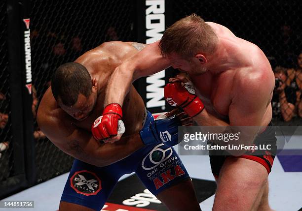 Josh Barnett punches Daniel Cormier during the Strikeforce event at HP Pavilion on May 19, 2012 in San Jose, California.