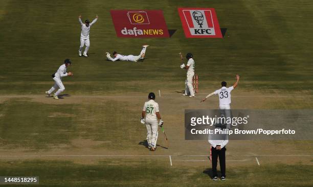 Ollie Pope catches Saud Shakeel of Pakistan as Harry Brook , Ben Duckett and Mark Wood celebrate during the fourth day of the second Test between...