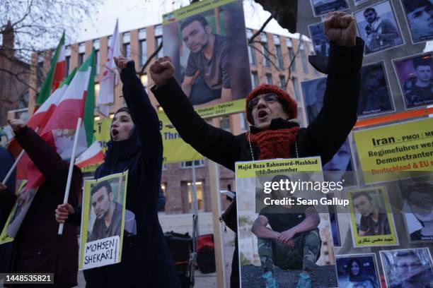 Protesters wear portraits of Majid Reza Rahnavard and Mohsen Shekari both of whom were recently executed by Iranian authorities, during a...