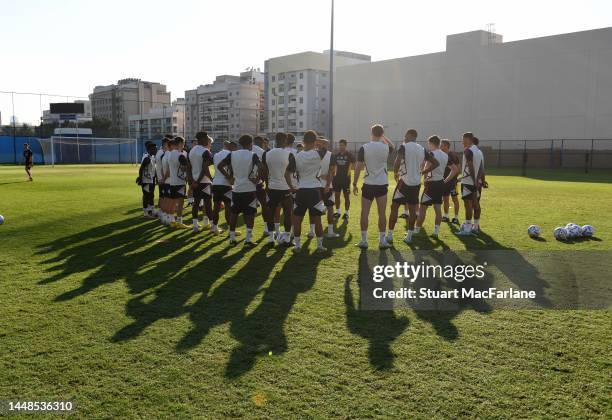 Arsenal manager Mikel Arteta talks to his players during a training session at Al Nasr Leisure Land Stadium on December 12, 2022 in Dubai, United...