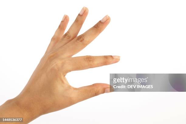 female hand on white background - pressure photos et images de collection