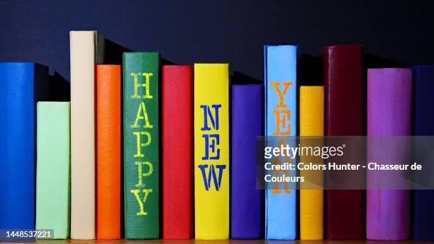 anonymous, colorful books with happy new year painted on the spine - book spine stock pictures, royalty-free photos & images