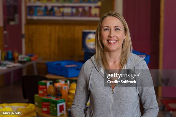 female volunteer at a food bank - mh stock pictures, royalty-free photos & images