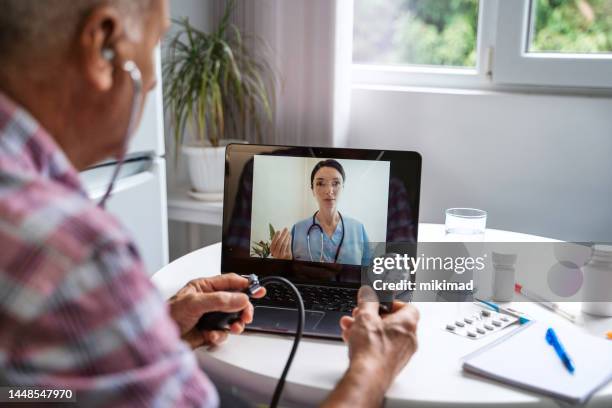 senior man make distant video call communicating with doctor online. - television controls stock pictures, royalty-free photos & images