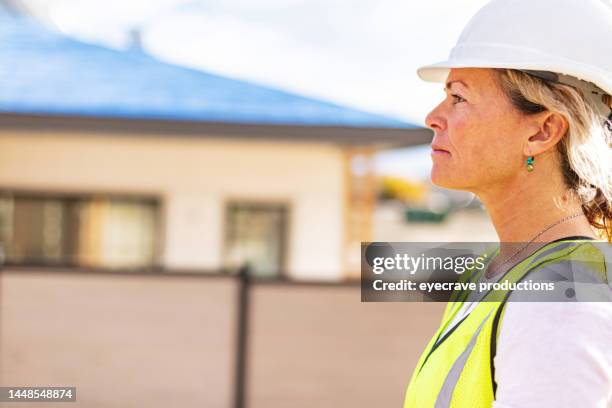 residential home development female contractor with blueprints on job site photo series - female builder stock pictures, royalty-free photos & images