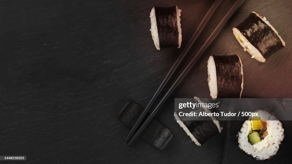 Sushi rolls with chopsticks copy space