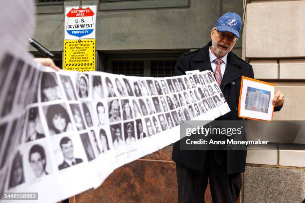 Paul Hudson, whose daughter Melina was one of the victims in the Pan Am Flight 103 Lockerbie bombing, holds up a banner of pictures of additional...