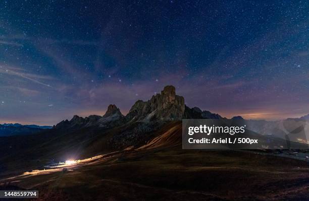 scenic view of mountains against sky at night,passo di giau,colle santa lucia,belluno,italy - colle santa lucia stock pictures, royalty-free photos & images
