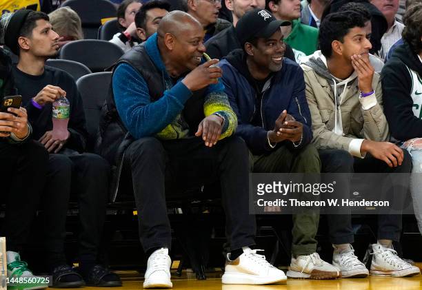 Comedians Dave Chappelle and Chris Rock from court side looks on during an NBA basketball game between the Boston Celtics and Golden State Warriors...