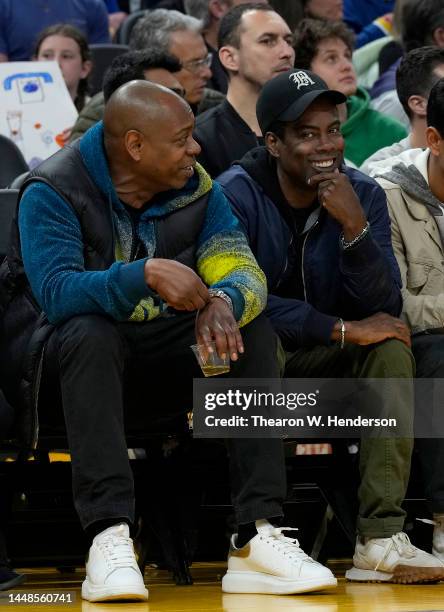 Comedians Dave Chappelle and Chris Rock from court side looks on during an NBA basketball game between the Boston Celtics and Golden State Warriors...