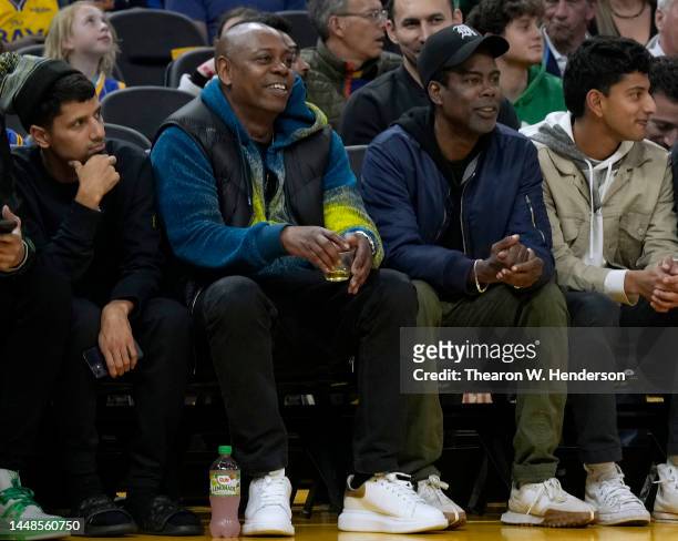 Comedians Dave Chappelle and Chris Rock from court side looks on during an NBA basketball game between the Boston Celtics and Golden State Warriors...