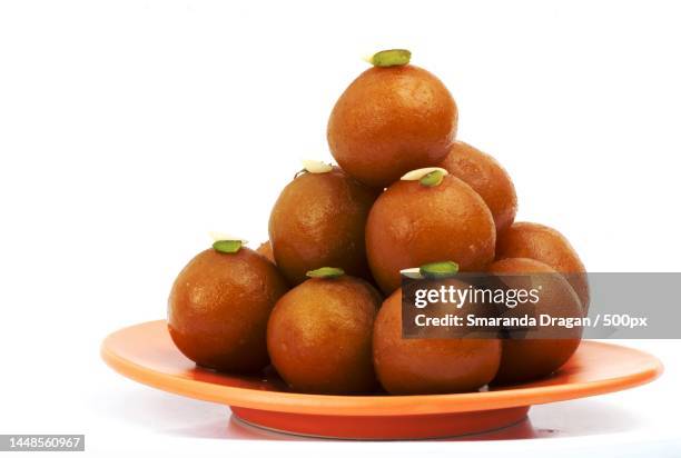 close-up of fruits in plate against white background - gulab jamun stock pictures, royalty-free photos & images