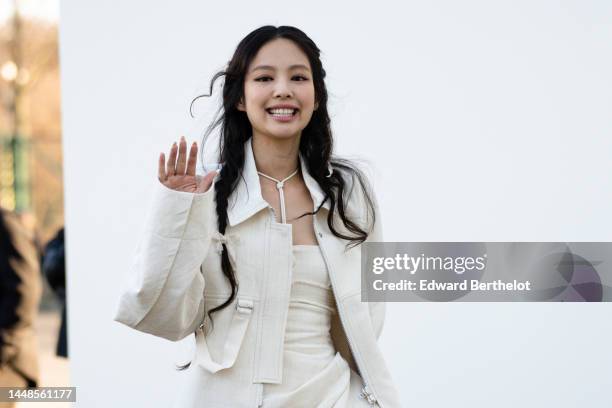 Jennie Kim from Blackpink wears a white oversize jacket, a necklace, a white ruffled and gathered mini dress, a white fluffy bag from Jacquemus,...