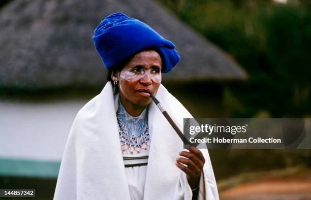 Xhosa women in traditional dress smoking pipe, Transkei, Eastern Cape