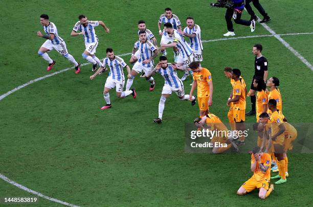 Argentina players celebrate after their win in the penalty shootout as Netherlands players react during the FIFA World Cup Qatar 2022 quarter final...