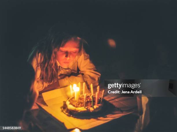 girl blowing birthday candles, blowing birthday cake, vintage 1990s family photo candid - 90 birthday stock pictures, royalty-free photos & images