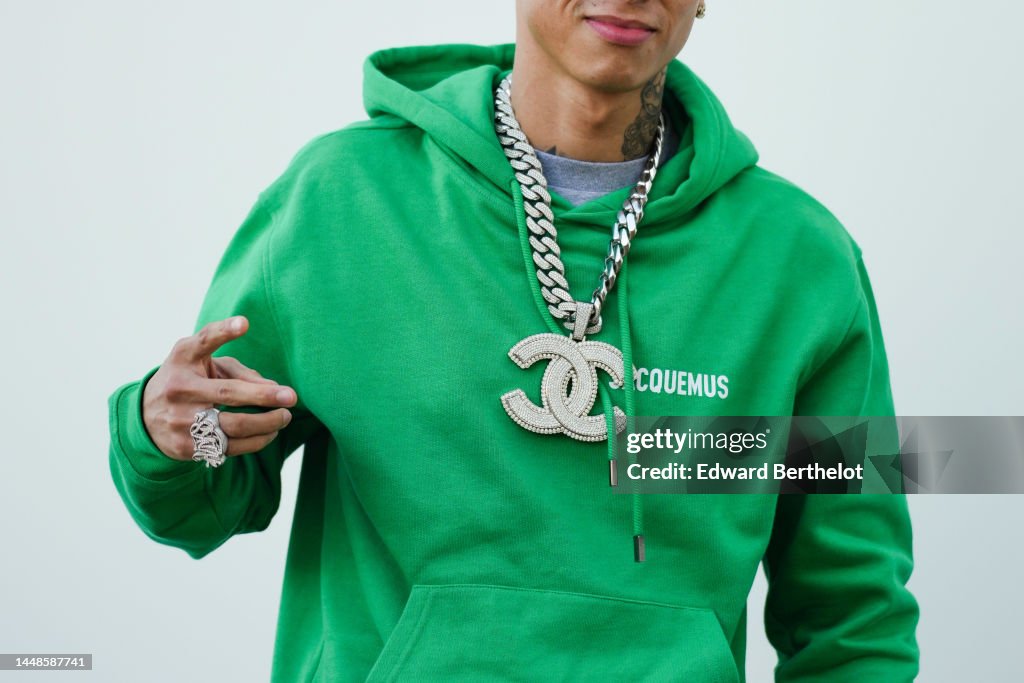 Central Cee wears a Chanel large logo necklace, a green hoodie... News  Photo - Getty Images