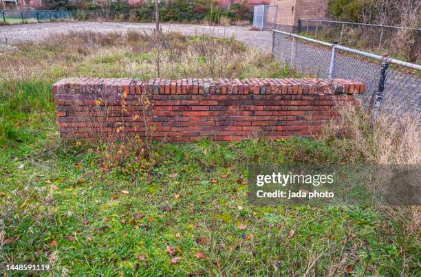 low stone wall on a lawn - stone wall garden stock pictures, royalty-free photos & images