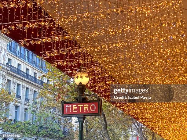 paris metro sign with christmas lights, paris, france - paris metro sign stock pictures, royalty-free photos & images