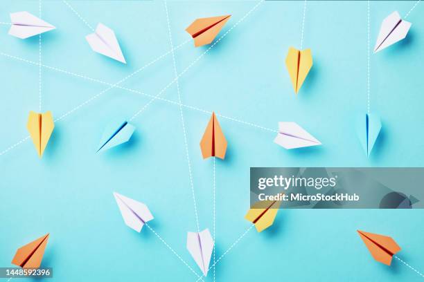 paper planes are connected by dotted lines on blue background - innovation hub stock pictures, royalty-free photos & images