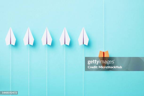 Paper Planes Flying On Different Directions On Blue Background