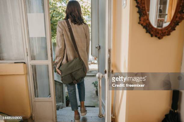 woman leaving home - left imagens e fotografias de stock