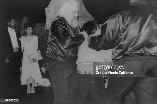 Musician Prince's bodyguards Lawrence Gibson and Charles "Big Chick" Huntsberry grab and assault photographer Richard Kolnsberg outside the...