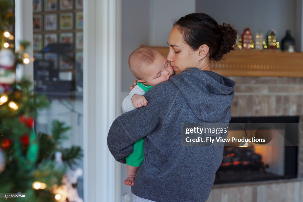 Mom Rocking Child Mom At Home For Christmas Rocking Baby To Sleep High-Res Stock Photo ...
