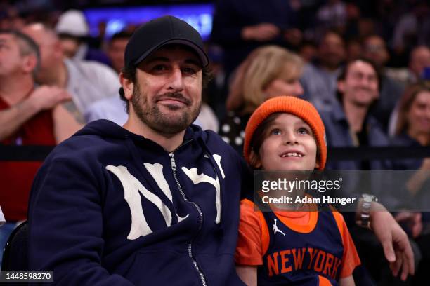 Actor Jason Biggs looks on with his son during the first half between the Atlanta Hawks and the New York Knicks at Madison Square Garden on December...
