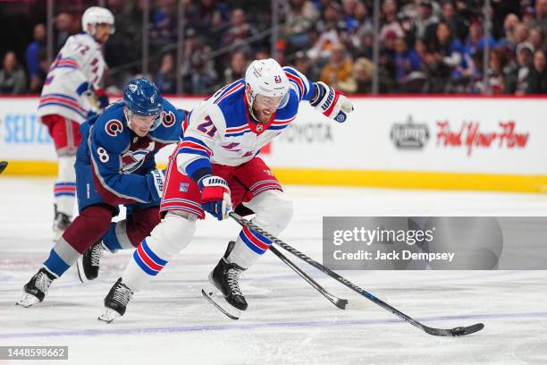 Barclay Goodrow of the New York Rangers moves the puck up the ice under pressure from Cale Makar of the Colorado Avalanche at Ball Arena on December...