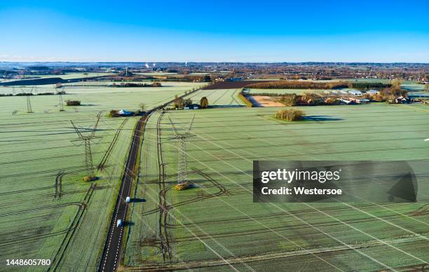 electricity pylons in nature - electric grid stock pictures, royalty-free photos & images