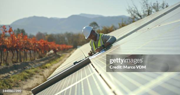 black man, engineer or solar energy management in electricity sustainability, solar panels or sun grid plant. worker, employee or technician on renewable energy farm, biodegradable environment or eco - solar energy stockfoto's en -beelden