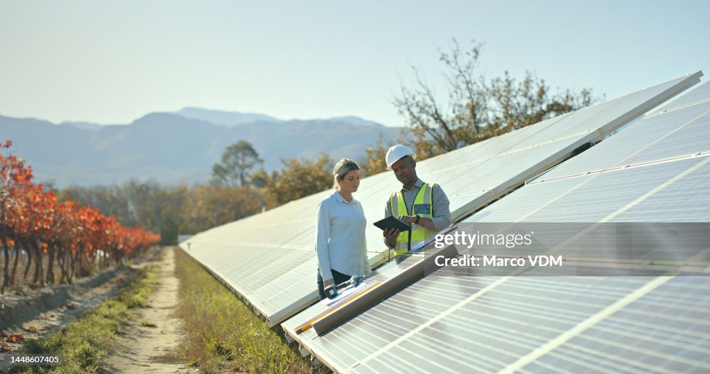 Solar energy, engineering team and planning on tablet in construction, architecture or renewable energy on farm. Digital tech, solar panels and industrial consulting logistics, sustainability and app