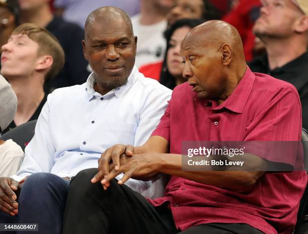 Hakeem Olajuwon and Elvin Hayes sit court-side as the Milwaukee Bucks play the Houston Rockets at Toyota Center on December 11, 2022 in Houston,...