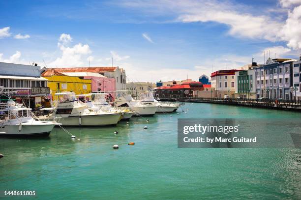 boats in a canal in downtown bridgetown, barbados - bridgetown barbados stock pictures, royalty-free photos & images