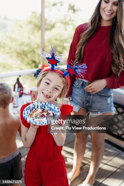 happy little girl eating ice cream on the fourth of july - 2 5 months stock pictures, royalty-free photos & images