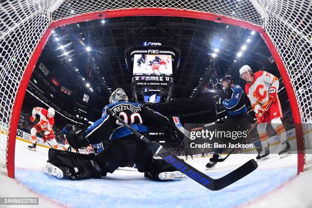 Goaltender Elvis Merzlikins of the Columbus Blue Jackets loses his stick while defending the net during the second period of a game against the...